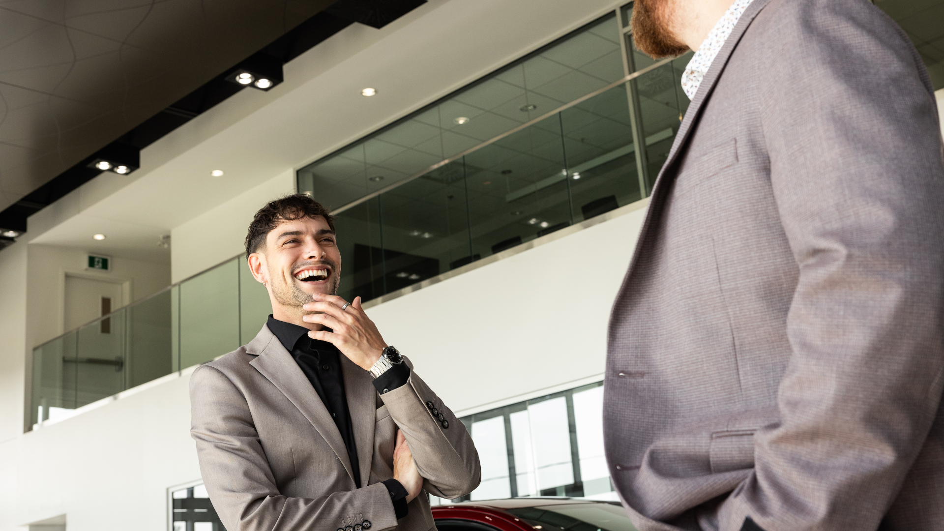 father and son choosing car at dealership